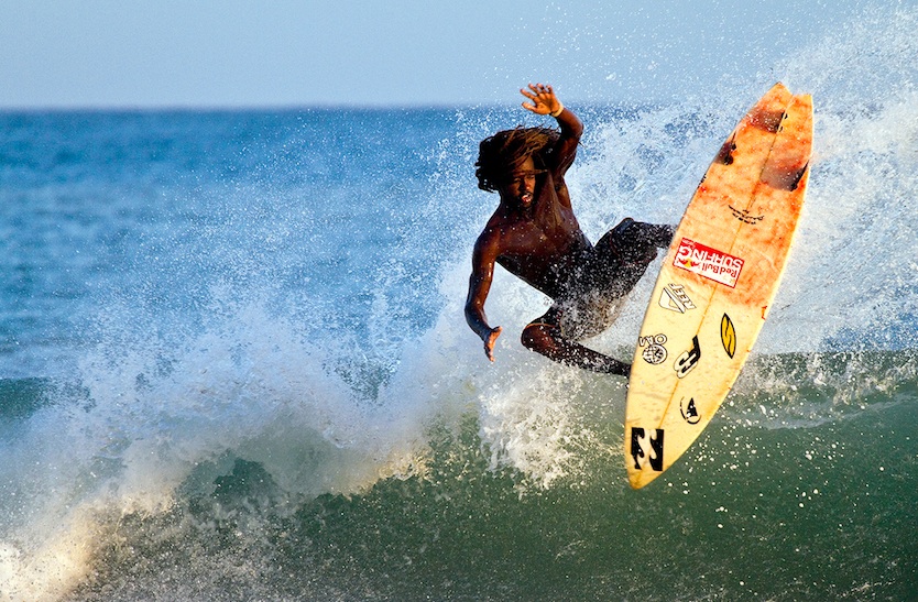 Icah Wilmot of Jamaica is one of the Caribbean\'s top surfers. Here he gets his fins out at a Haitian river mouth.  Photo: John Seaton Callahan.

